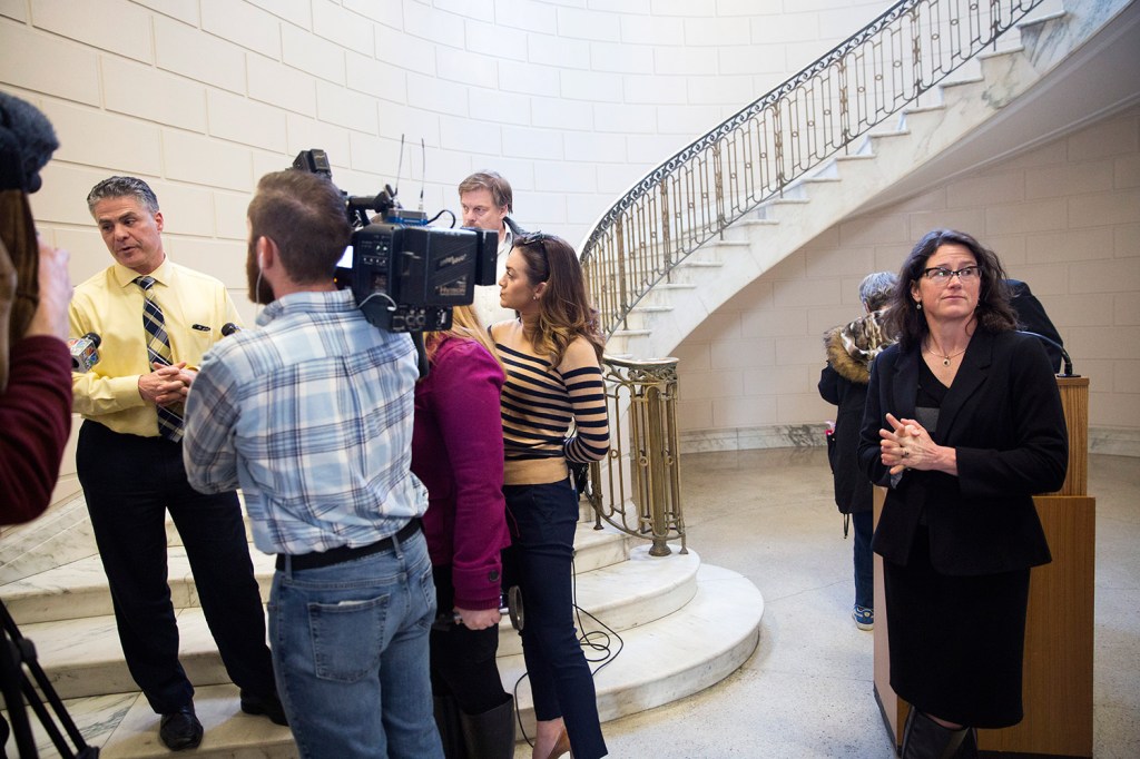 Portland City Councilor Belinda Ray, right, listens to Mayor Ethan Strimling speak to the media after councilors held a news conference to express support for Police Chief Michael Sauschuck's plan to start having officers use body cameras. Strimling and the American Civil Liberties Union of Maine have called for a quicker implementation of the cameras, in response to a fatal police shooting Saturday in Portland.