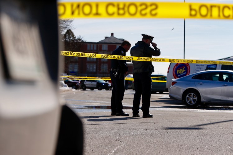 Portland police examine the scene where an officer shot Chance Baker at Union Station Plaza on Saturday.