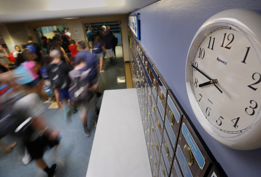 Students bustle before classes at Westbrook High School in 2015. A bill now before the Legislature's Education Committee would mandate a start time no earlier than 8:30 a.m. for high schools statewide.