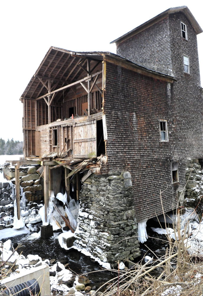 Water flows under the mill Tuesday on Branch Mills Road in China. The mill is being dismantled, and when the job is finished, the Atlantic Salmon Federation is expected to buy the site.