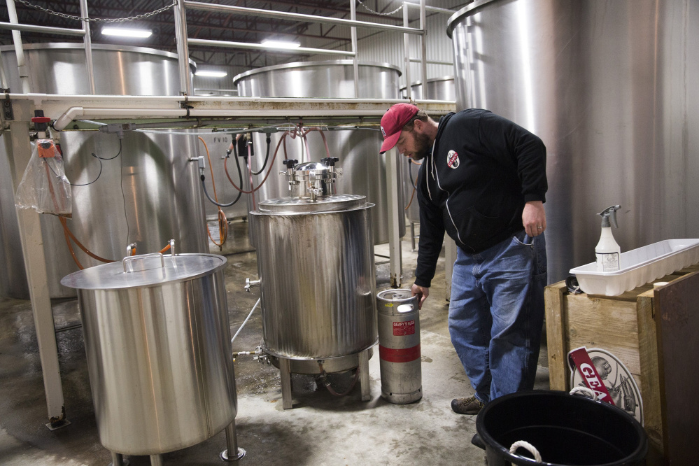 Peter Heggeman, the head brewer at D.L. Geary Brewing Co., Maine's original microbrewery, shows off some small-batch brewing equipment in Portland in November. Geary's is being sold to a Freeport businessman who intends to introduce new specialty brews. Alan Lapoint has taken over management of the 34-year-old brewery and hopes to complete the acquisition by the end of the year. Staff photo by Brianna Soukup