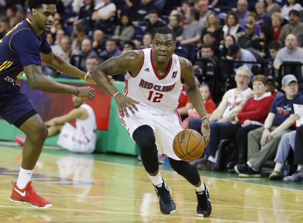 Maine's Jalen Jones, right, drives past Salt Lake City's Quincy Ford in the third quarter of the Red Claws' 104-95 win Sunday at the Portland Expo.