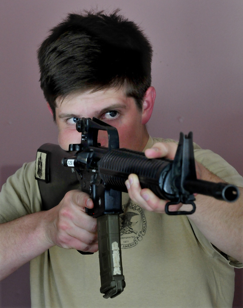 National Guardsman Max Nickerson, of Winslow, takes aim with an unloaded rifle to recreate shooting one of the firearms he used to become the overall winner of the U.S. Army Small Arms Championships.