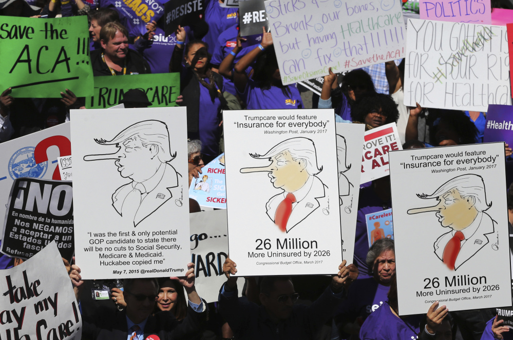 Hundreds march through downtown Los Angeles protesting President Trump's health care bill. Much of the current plan is now in the hands of Trump administration officials.
