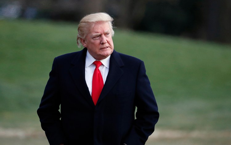 President Trump walks to the White House after arriving on Marine One, Sunday after a weekend at his Mar-a-Lago estate in Palm Beach, Fla. 