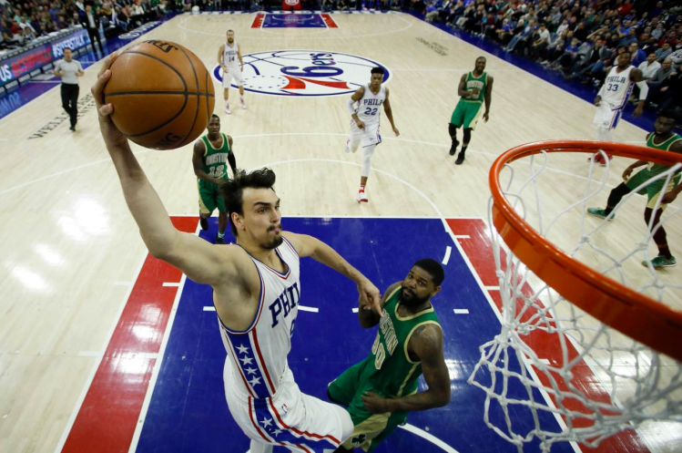 Philadelphia's' Dario Saric goes up for a shot against Boston's Amir Johnson during the second half of Sunday in Philadelphia. Philadelphia won 115-99. 