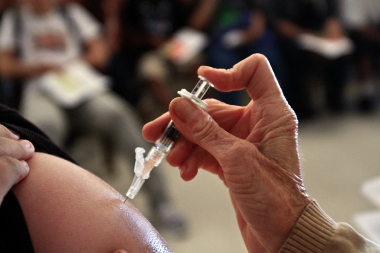 A student receives a whooping cough shot in Huntington Park, Calif., in 2014. While Maine's vaccine rules remain among the nation's most lenient, California responded to rising opt-out rates by barring unvaccinated children from coming to school unless they have medical reasons for not being immunized.