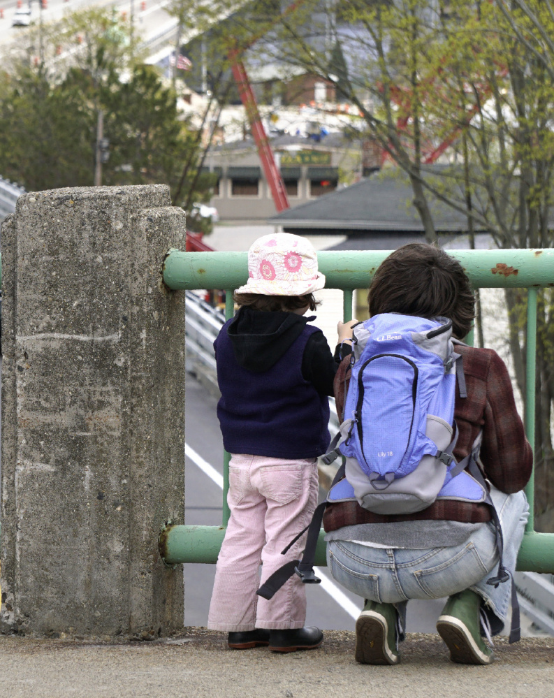 Amy Chamberlain watches traffic move over the newly opened viaduct in Bath with her daugher Juniper Branca-Chamberlain, 3, on Wednesday. The two followed the progress of the construction through the winter.