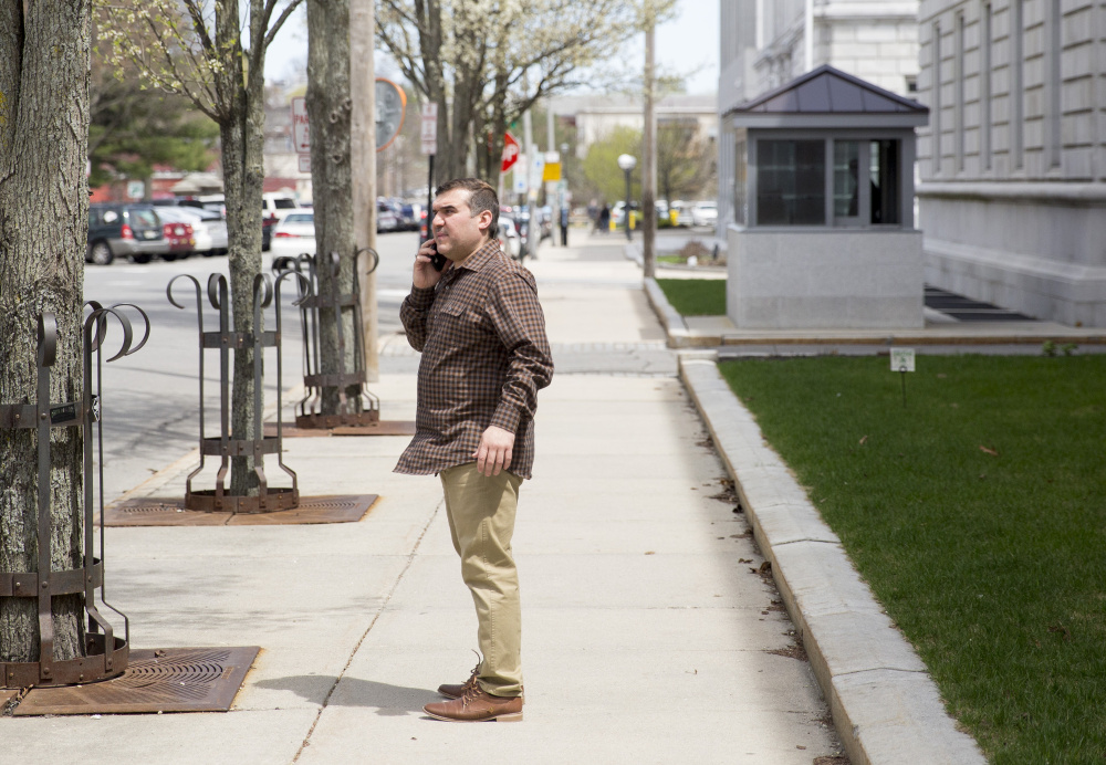 Ali Ratib Daham, 40, talks on the phone outside the federal courthouse in Portland in May. He and his brother Abdulkareem Daham, 21, were charged with perpetrating a scheme to defraud the government of tens of thousands of dollars through their operation of the Ahram Halal Market on Forest Avenue.