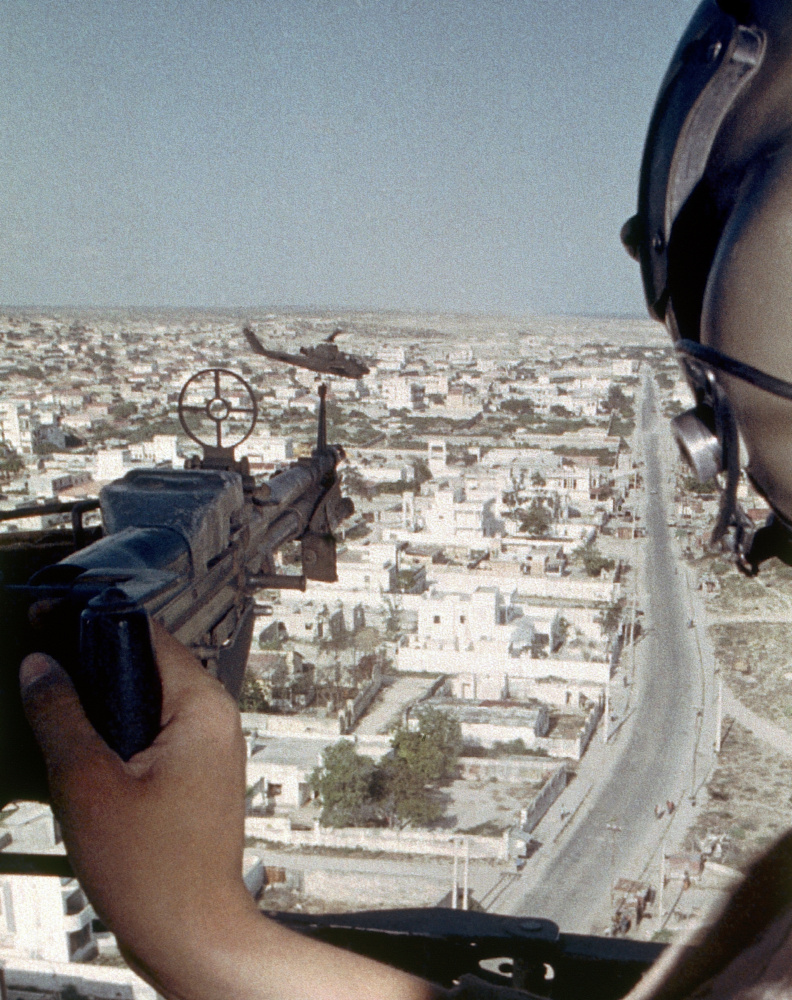 The gunner of a U.S. Army Black Hawk helicopter covers a Cobra gunship during a patrol over Mogadishu, Somalia, on Oct. 17, 1993. Kyle Milliken's death in Somalia on Friday was the first American casualty since the "Black Hawk Down" mission in 1993.