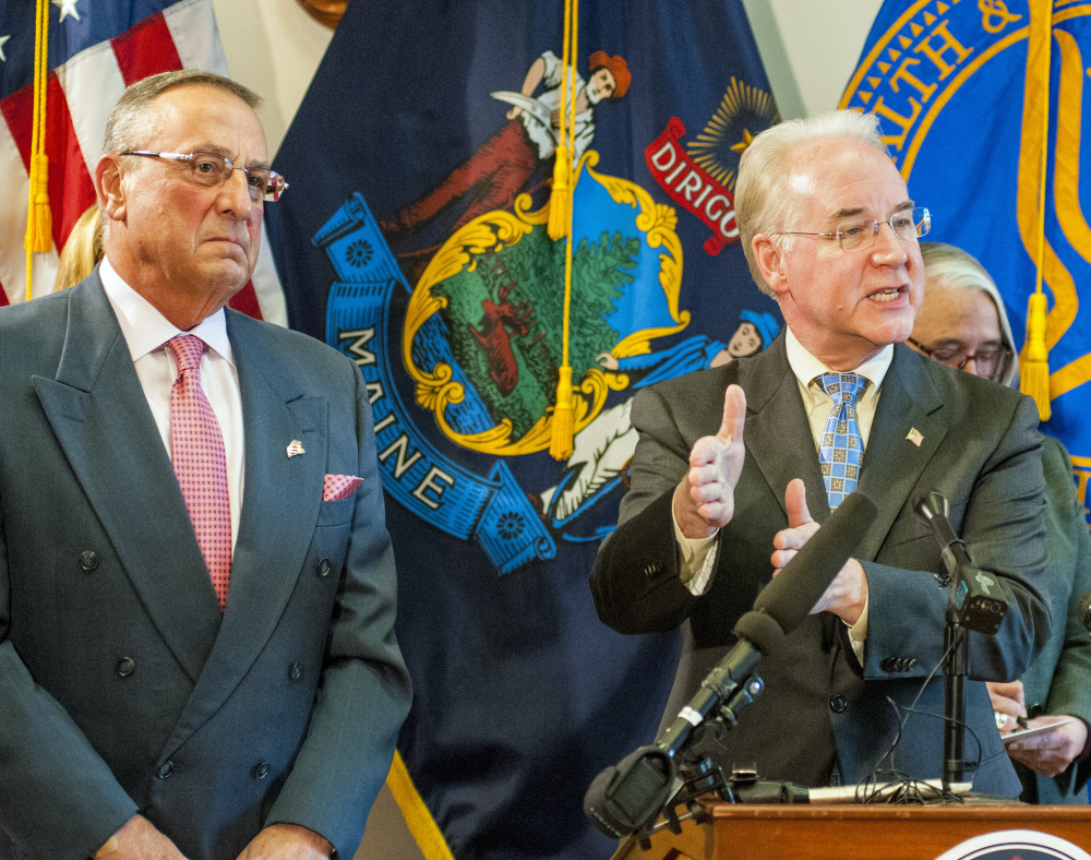 Gov. Paul LePage, left, listens as U.S. Health and Human Services Secretary Tom Price answers a reporter's question on Wednesday at the State House in Augusta.