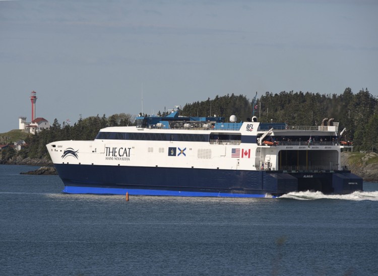 The Cat passes the Cape Forchu Lighthouse as it leaves Yarmouth, Nova Scotia, on June 15, 2016.