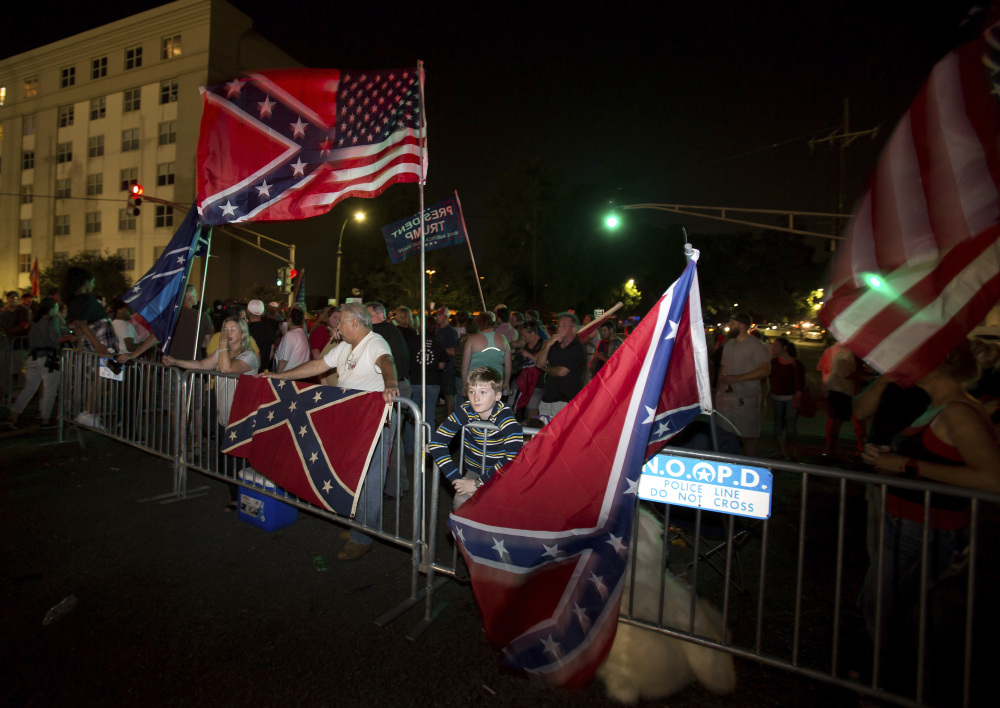 Pro-monument protesters gather as the Confederate general P.G.T. Beauregard is removed Tuesday, May 16, 2017, from the entrance to City Park in New Orleans.   The removal of the statue comes after the city has already taken down a statue of Jefferson Davis, the Confederacy's only president,  and a memorial to a white rebellion against a biracial Reconstruction-era government in the city.  (AP Photo/Scott Threlkeld)