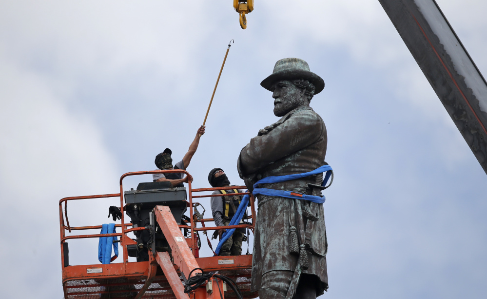 Robert E. Lee's statue is taken down in New Orleans on May 19. Statues of Confederate leaders were put up "to send a strong message ... about who was still in charge in this city," Mayor Mitch Landrieu said.