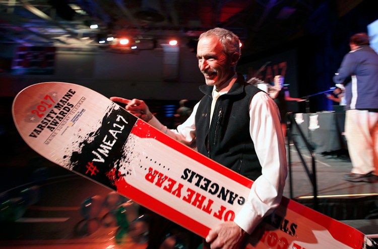 Steve DeAngelis, of Maranacook High School, leaves the stage after accepting the Coach of the Year award.