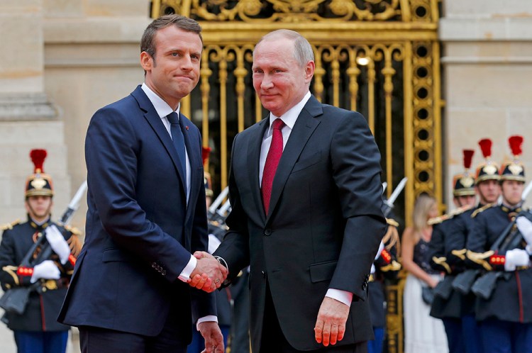 Russian President Vladimir Putin is welcomed by French President Emmanuel Macron at the Palace of Versailles, near Paris, Monday. Macron is the first Western leader to meet with Putin after the G7 Summit over the weekend where relations with Russia were a key part of the agenda.