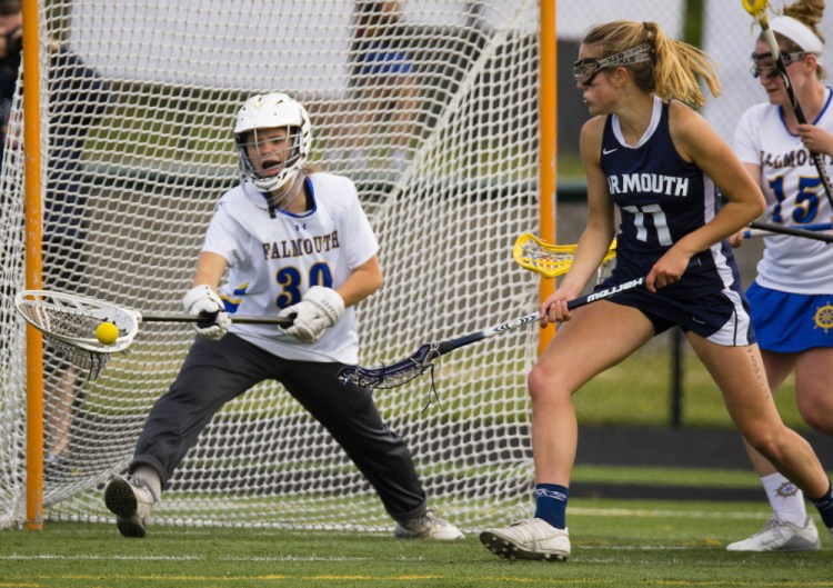 Falmouth goalie Mary Budri makes a save as Yarmouth’s Ella Antolini looks on. Antolini scored three goals, including the winner, as Yarmouth completed an unbeaten regular season.