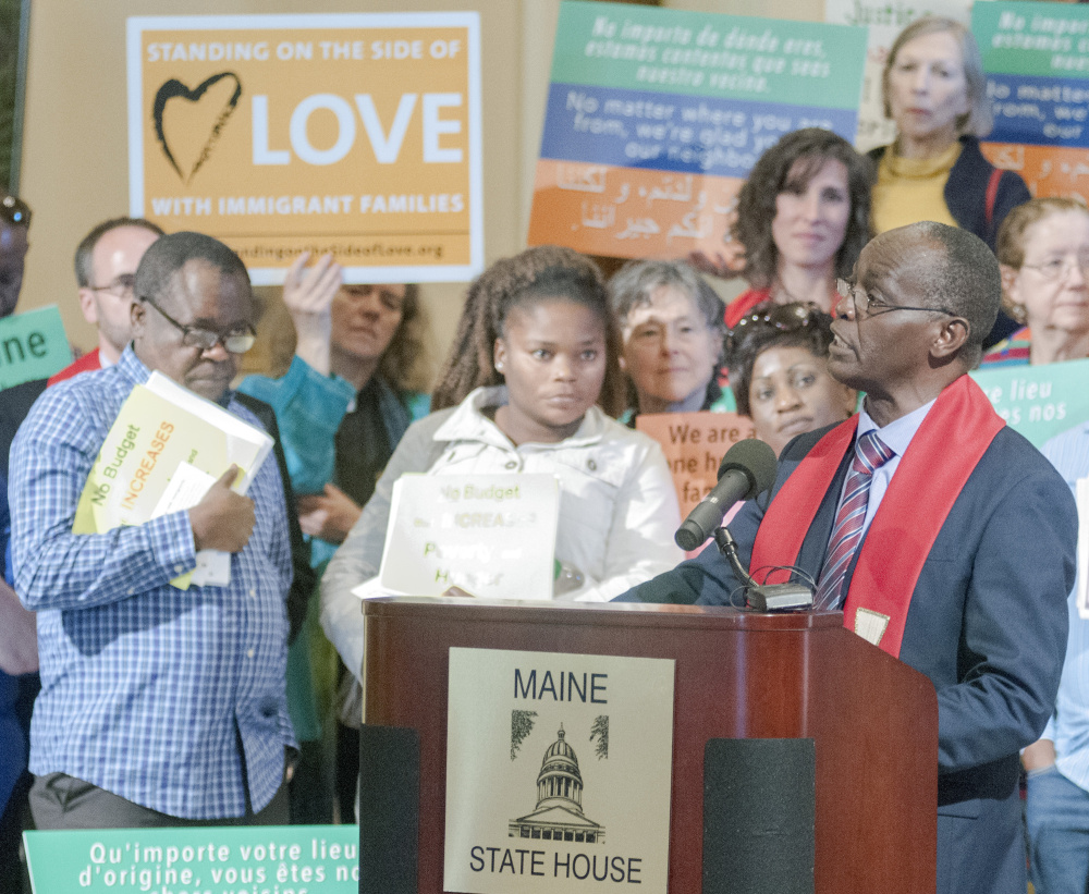 Staff photo by Joe Phelan
The Rev. Nathan Ndayiziga speaks Wednesday at a rally about immigration led by religious leaders in the State House Hall of Flags in Augusta.