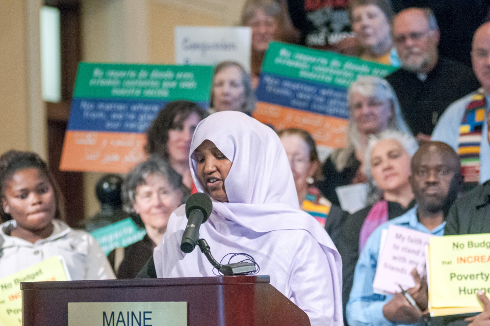Staff photo by Joe Phelan
Fatumah Hussein speaks Wednesday at a rally about immigration led by religious leaders in the State House Hall of Flags in Augusta.