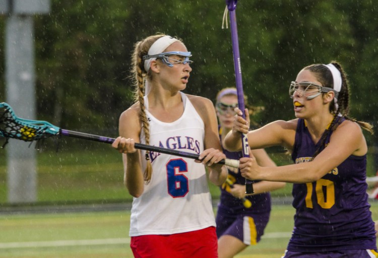 Photo by Elise Klysa 
 Messalonskee's Molly Mackenzie (6) prepares to pass the ball against Cheverus during a Class A North semifinal Friday at Thomas College in Waterville.