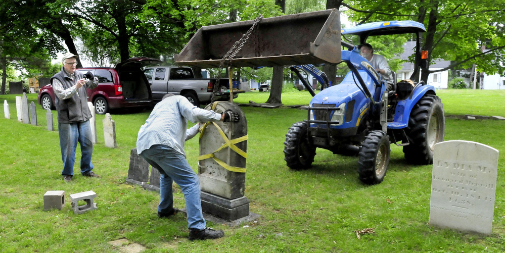  Bill King takes photos as Hank McIntyre sets the stone while Logan Johnston lowers it from his tractor.