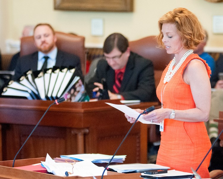 Sen. Amy Volk, R-Scarborough, reads testimony during Wednesday's debate from several waitresses who said their wages with tips were $20 to $30 an hour but without the tip credit their incomes were declining. 