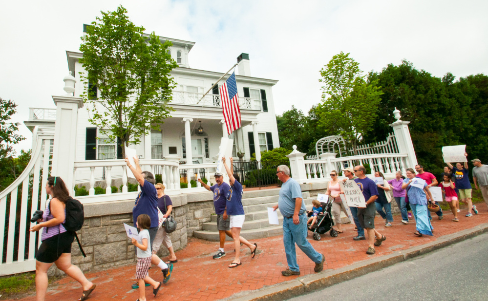 Members of the Maine State Employees Association and supporters rally on Saturday morning in front of the Blaine House in Augusta to protest lawmakers' failure to pass a budget, which triggered a state government shutdown at midnight Friday.