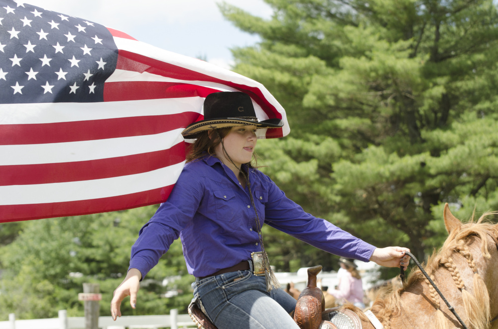 Jami Paquette, a friend of Halee Cummings, opens the Memorial Barrel Race held at the Silver Spur Riding Club in Sidney on Sunday.