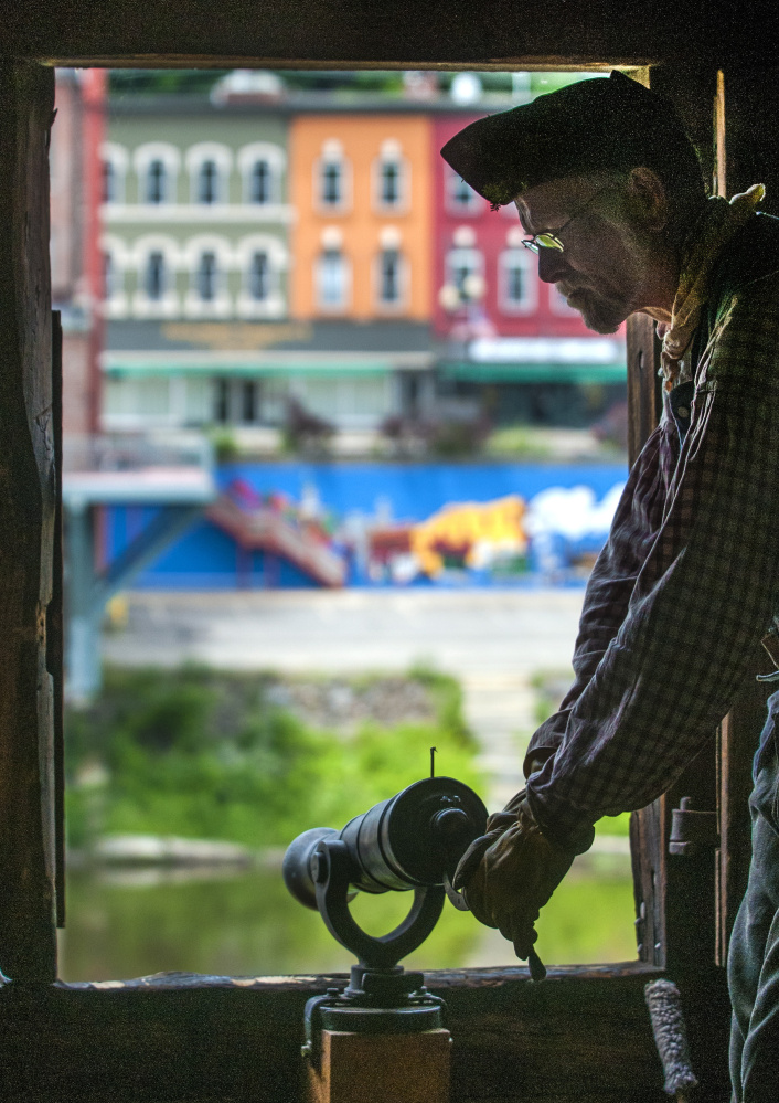 Re-enactor Greg Edwards prepares a 1-pound swivel gun for firing around noon Tuesday at Old Fort Western in Augusta. The four cannons in the blockhouse were fired 13 times – once for each of the United States' original 13 colonies.