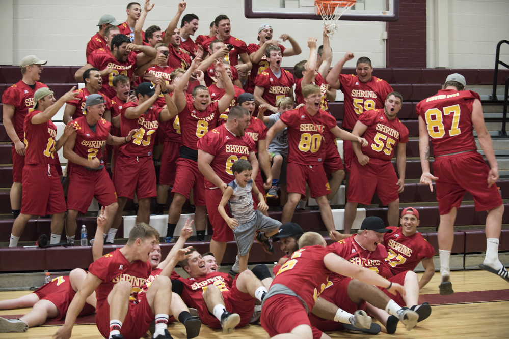 Members of the East team ham it up during Lobster Bowl media day at the Foxcroft Academy gymnasium in Dover-Foxcroft on Tuesday. (Kevin Bennett Photo)