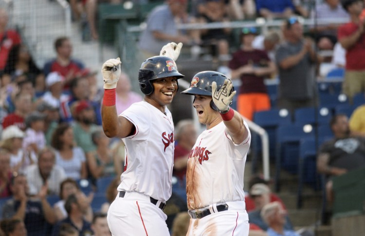 Mike Olt, right, is greeted at home by Jeremy Barfield after Olt hit a three-run home run in the third inning of Thursday's game against Hartford at Hadlock Field in Portland. The Sea Dogs hit five home runs and won, 12-6.