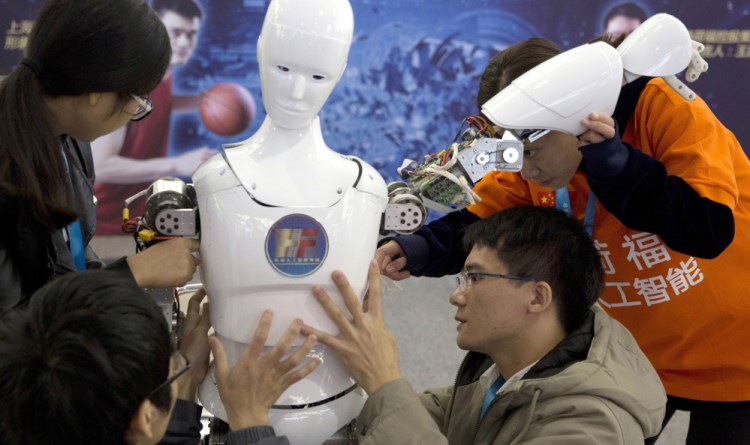 Chinese students with Ares, a bipedal robot they designed, in this 2016 photo. China hopes to use artificial intelligence to generate $59 billion of annual economic output by 2025.