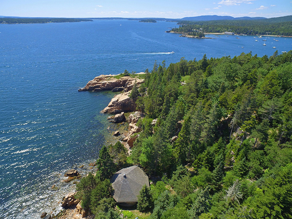 The property sale includes the round "study" along the cliff edge, center at bottom, where David Rockefeller wrote his memoirs, according to the listing agent, and there are granite outcroppings and almost a half-mile of shoreline.