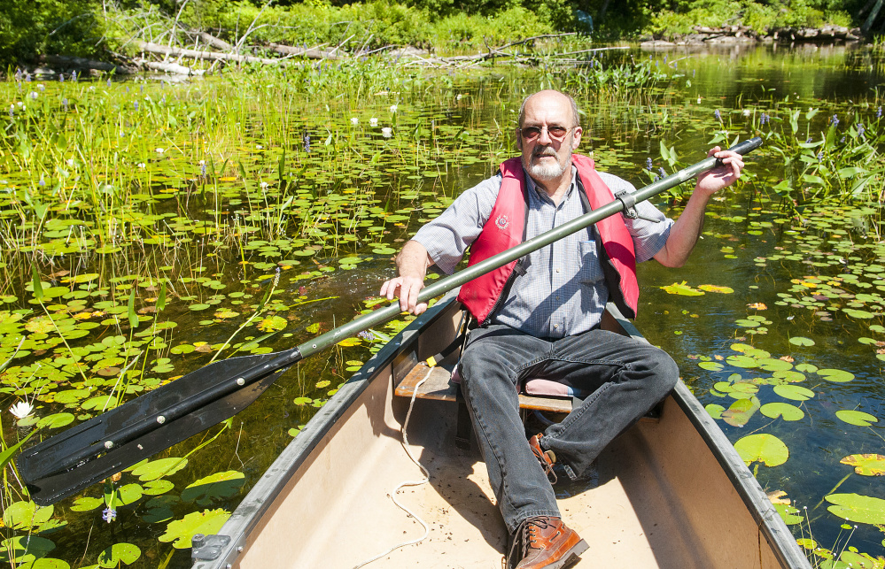 John Andrews paddles a canoe Wednesday on David Pond, which is in Fayette and Chesterville. Somethigns difromg story akdg and why we cares kg kdkg ks adkg ksadgk