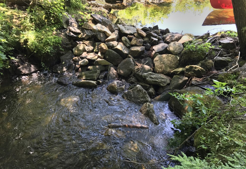 This rock impoundment holds back water Wednesday on David Pond, which is in Fayette and Chesterville.