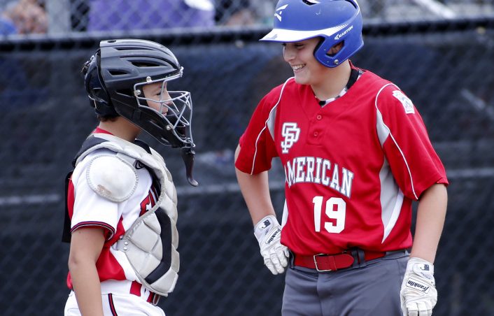 Nolan Hobbs of South Portland American shares a laugh with Connecticut catcher Aiden Rivera.  (Staff photo by Derek Davis)