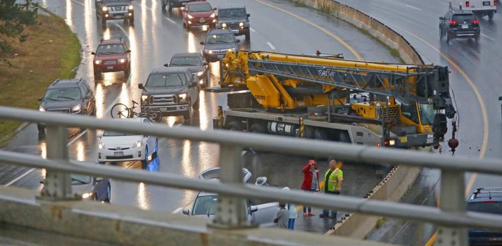 Traffic is slowed in both directions after a crane crashed in the southbound lane just south of Tukey's Bridge on Interstate 295 in Portland on Friday afternoon.