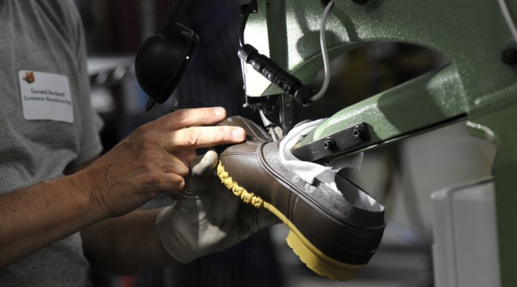 Gerard Bechard works on a trimmer at L.L. Bean's production plant in Lewiston. The company is a model for other businesses in Maine.