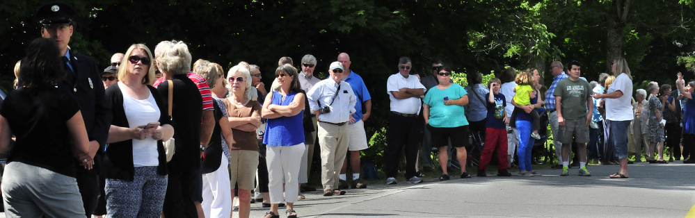 Mourners of former China Village Fire Chief George Studley line Causeway Road on Sunday in China as a procession of area firefighters makes its way to the fire station for a memorial service.