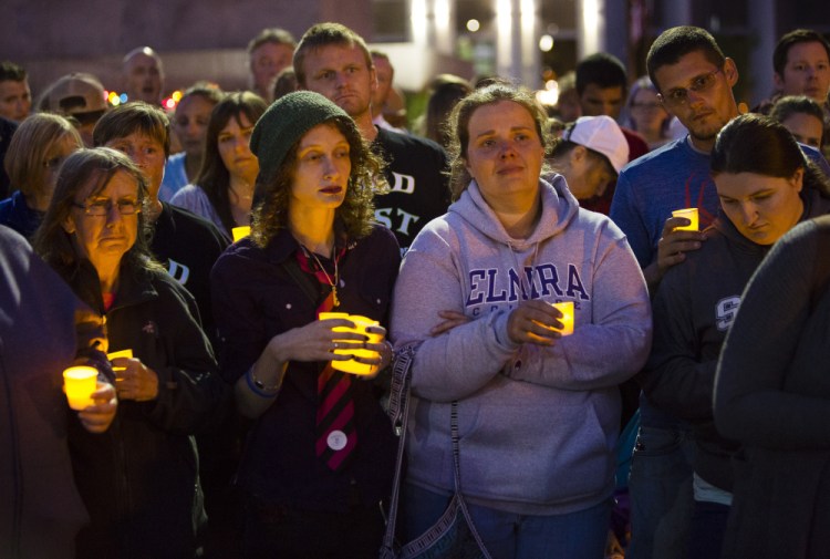 People remember those who died of drug overdoses as they attend a vigil on August 31 in Portland's Monument Square. 2016 saw 376 drug deaths in Maine, and the 2017 toll is on pace to set a new record. 