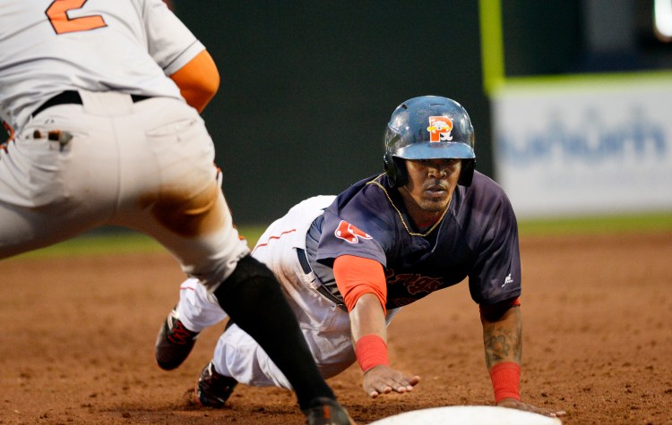 Portland's Joseph Monge dives back to first on a pickoff attempt in Friday night's game at Hadlock Field.