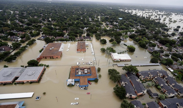 Water from Addicks Reservoir flows into neighborhoods as floodwaters from Harvey rise on Aug. 29 in Houston. 