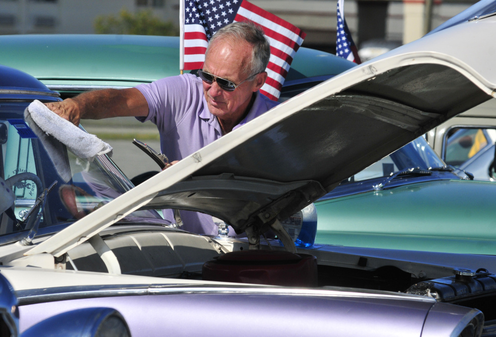 John Kirby of New Gloucester polishes the windshield on his 1955 Ford Fairlane on Saturday during a Hurricane Harvey fundraising car show at the Augusta Civic Center.