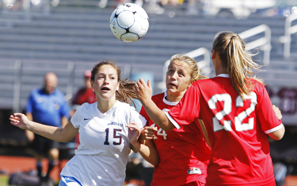 Windham's Hannah Kaplan, left, battles with Kaya Beckman, center, and Lauren Elsemore of South Portland in the second half of their girls' soccer season opener Saturday in Windham. Kaplan scored her team's second goal in a 2-0 win.