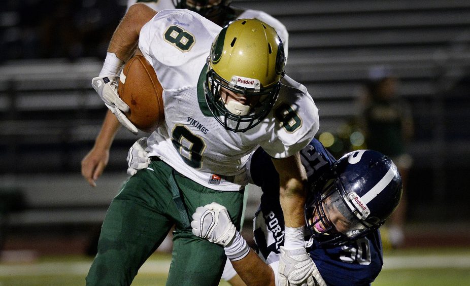 Dawson Stevens of Oxford Hills/Buckfield is tackled by Portland's Benjamin Levine during a Class A North season opener Saturday night at Fitzpatrick Stadium. Oxford Hills won, 20-14.