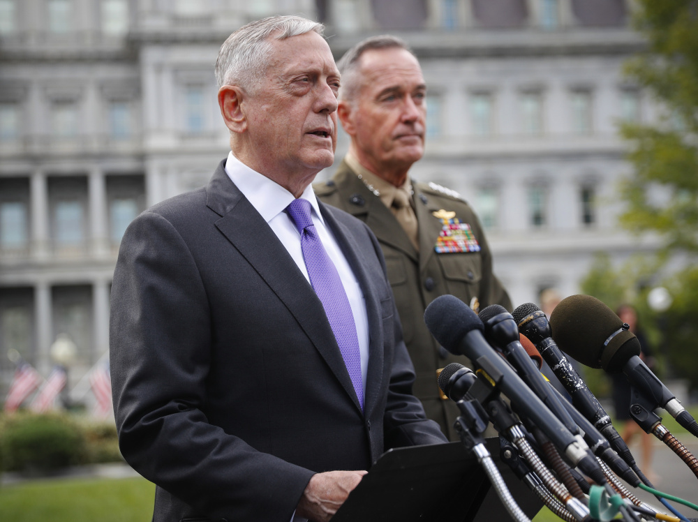 Defense Secretary Jim Mattis, left, accompanied by Joint Chiefs Chairman Gen. Joseph Dunford, right, speaks to members of the media outside the West Wing of the White House in Washington, Sunday, Sept. 3, 2017, regarding the escalating crisis in North Korea's nuclear threats. (AP Photo/Pablo Martinez Monsivais)