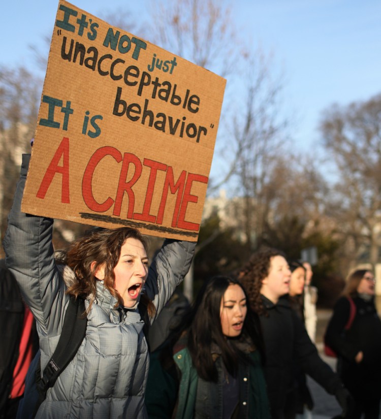 Northwestern University student Becca Schwartz, left, marches in support of rape survivors Feb. 10 in Evanston, Ill. The failure of parents and educators to speak openly about sex puts young people at risk when they get to college.