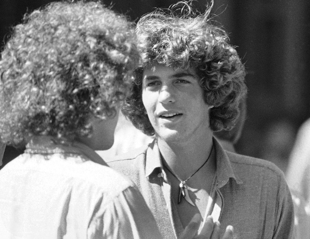 John Kennedy, son of President John F. Kennedy, talks to a friend during registration day activities at Brown University in Providence, R.I. Brown University said Kennedy's college application now up for auction was stolen.