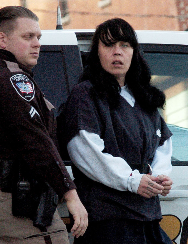 Miranda Hopkins, shown  Jan. 17 being led into court in Belfast, is charged with manslaughter in the death of her infant son.