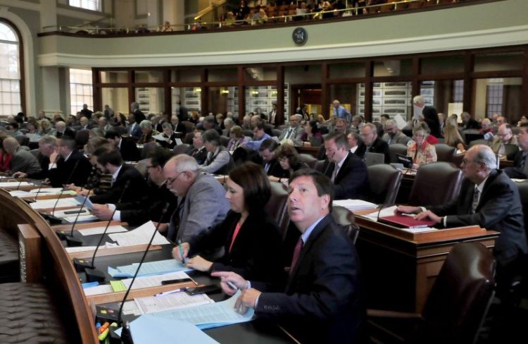 Rep. Kenneth Fredette, R-Newport, looks up at the electronic voting board – which was not working properly – during a special session of the Legislature on Monday.